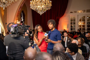A young man being interviewed by the news during a press conference in Los Angeles, California.
