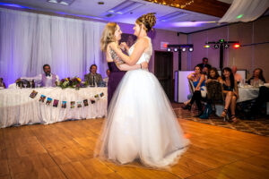 A bride and daughter dance at a wedding in Cambria, California.