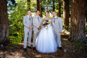 A bride poses with her family at her wedding in Cambria, California.