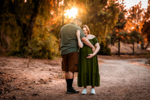 Photo of a couple embracing one another as they expect a baby.
