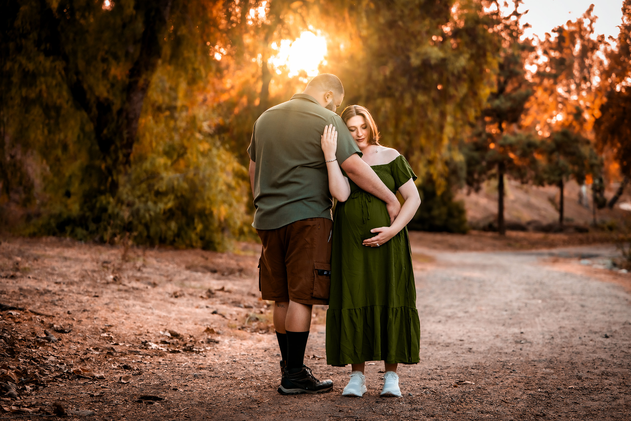 Ventura Maternity Shoot Photo of a couple embracing one another as they expect a baby.