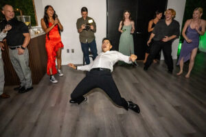 A man is dancing at a wedding reception in Long Beach, California.